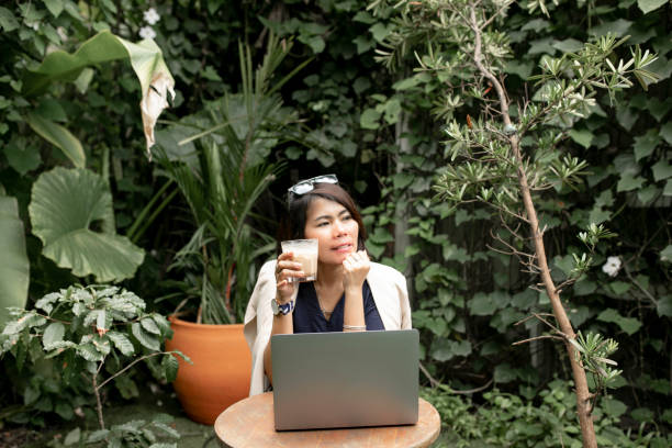istock asian female working at the cafe park with using laptop 1301339462