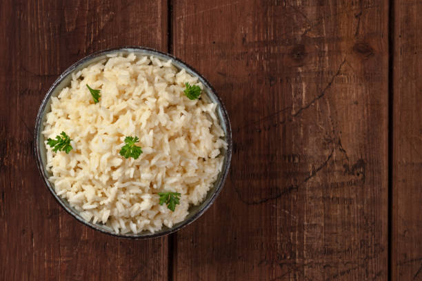 istock White rice with parsley, top shot on a rustic wooden background 1301343076
