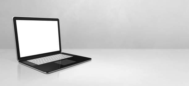 istock Laptop computer on white concrete office scene background banner 1301344993