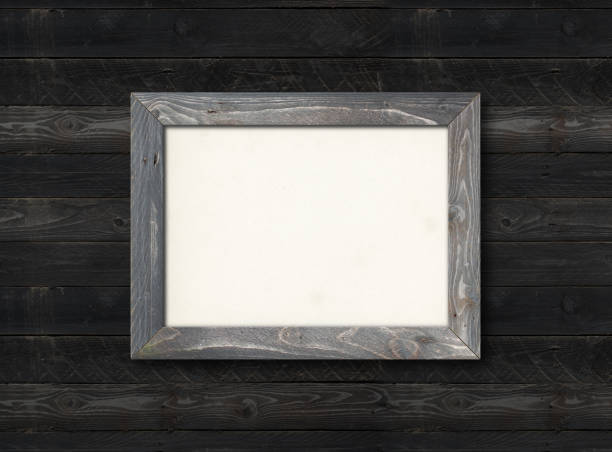istock Old rustic wooden picture frame hanging on a light blue wall 1301345024