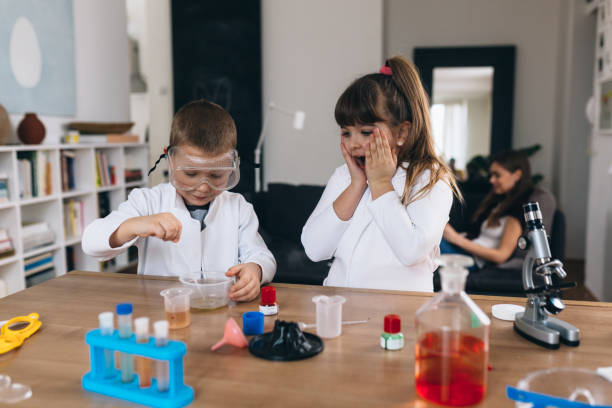 istock brother and sister do science experiments at home 1301345145
