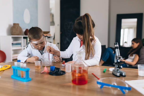 istock brother and sister do science experiments at home 1301346547