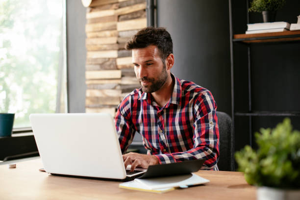 istock Businessman sitting at office desk working on new project 1301348968
