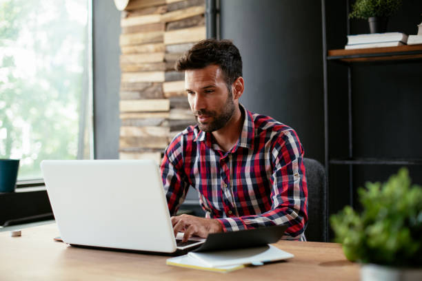 istock Businessman sitting at office desk working on new project 1301348993