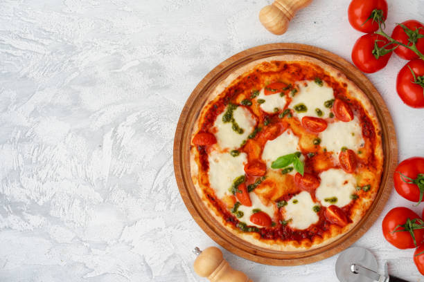 istock Top view of pizza Margherita on gray surface 1301349993