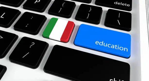 Photo of Computer keyboard with word Education and Italian Flag, selected focus on enter button.