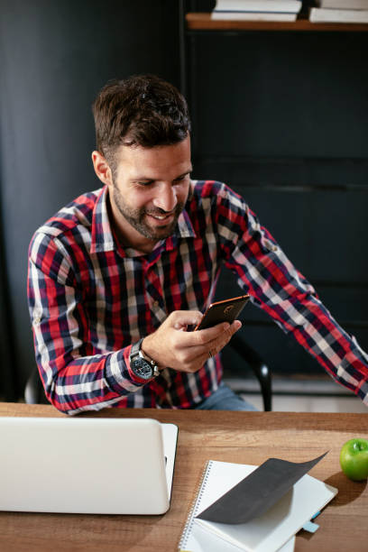 istock Company manager on his phone sending a message. 1301350619
