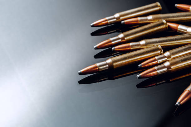 istock Rifle bullets or cartridges on black shiny background 1301350958