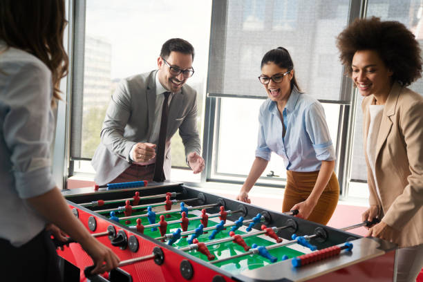 istock Excited diverse employees enjoying funny activity at work break, creative friendly workers play game 1301352435