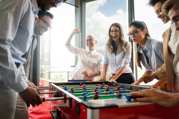 istock Employees playing table soccer indoor game in the office during break time 1301352453