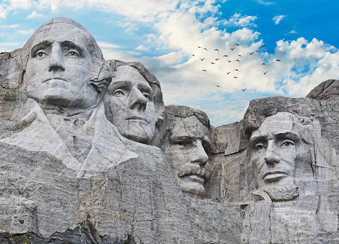 Mount Rushmore National Memorial highlighted by the sculpture of four American presidents carved into the mountainside located in the Black Hills of Pennington County, South Dakota.