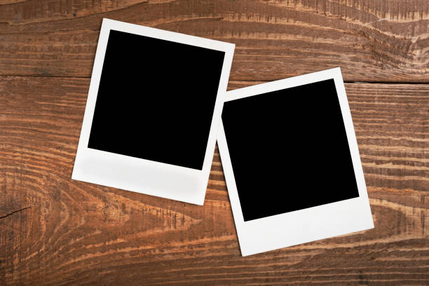 two photos taken with a polaroid empty content mockup of two instant photos on a polaroid on a wooden background and copy space two objects photos stock pictures, royalty-free photos & images