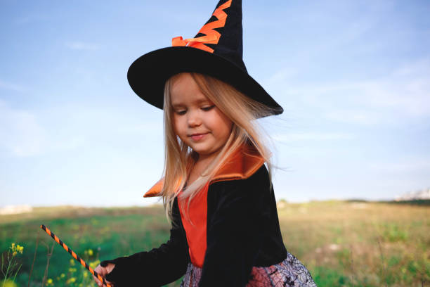 istock little girl dressed as a witch celebrates halloween 1301356608