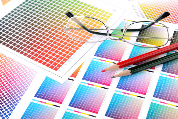 istock Desk in design office, pencils and glasses on color chart 1301359522