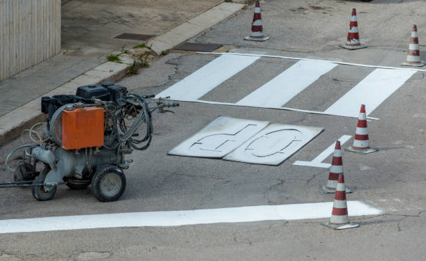 istock machine and workers at road construction use for road and traffic sign painting 1301360739