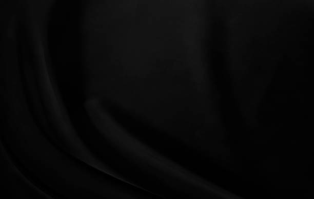istock Black gray satin dark fabric texture luxurious shiny that is abstract silk cloth background with patterns soft waves blur beautiful. 1301360913