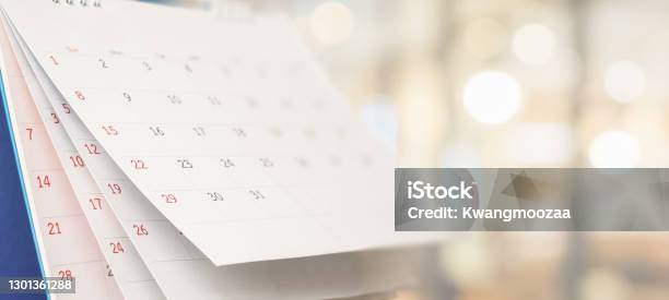 Close Up White Paper Desk Calendar With Blurred Bokeh Background Appointment And Business Meeting Concept Stock Photo - Download Image Now