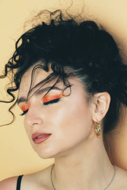 istock Beautiful young brunette model with bright make-up and curly hairstyle 1301362304