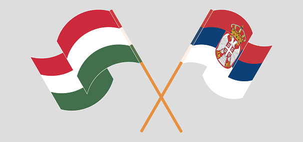 Crossed and waving flags of Hungary and Serbia. Vector illustration