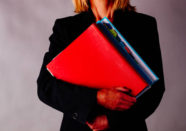istock Business woman holding a folder 1301362636