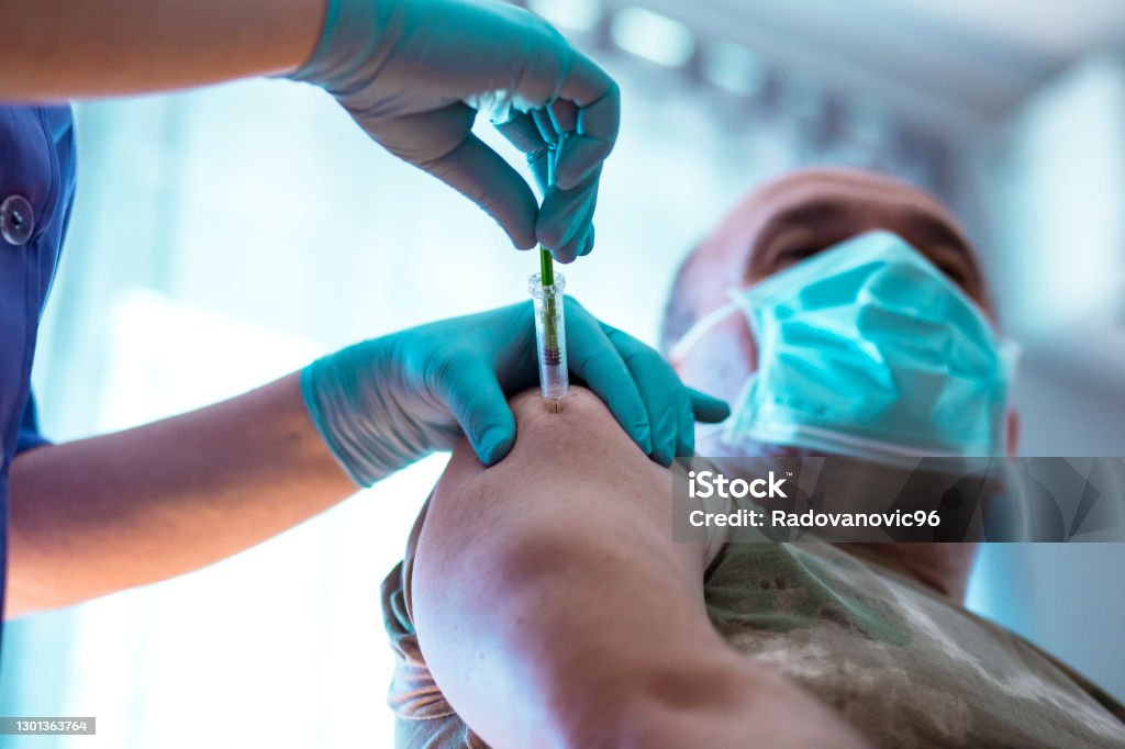 A military veteran taking vaccine against COVID-19 Vaccination Stock Photo