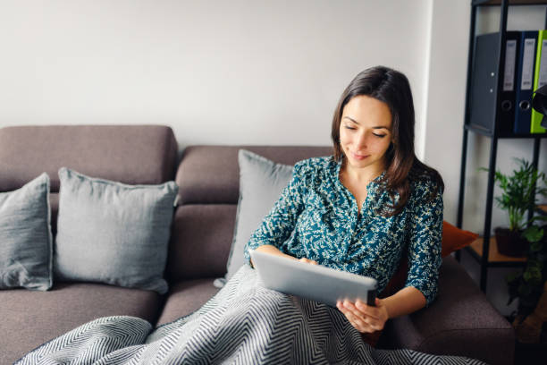 istock Smiling caucasian woman using a digital tablet stock photo. 1301365540
