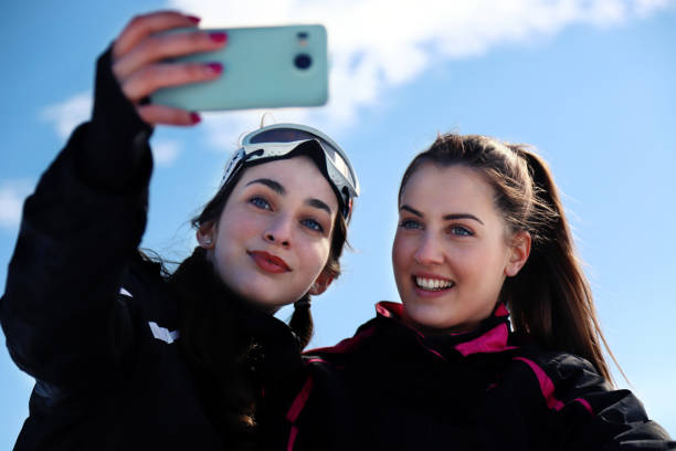 istock Two women in the mountain taking selfies stock 1301365585