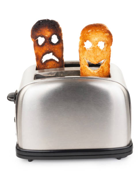 istock Toasts with smiley face in toaster 1301366835