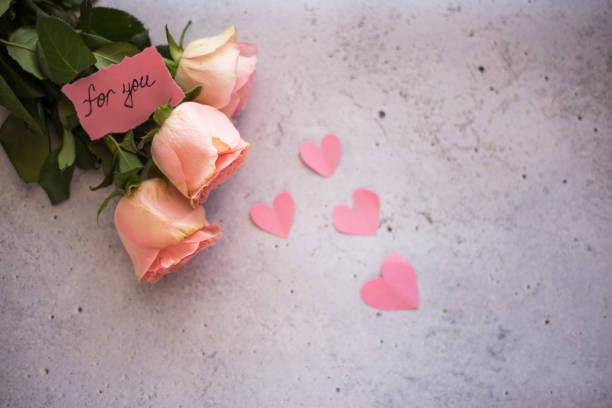 istock Rose flowers and heart shaped decorations 1301369723