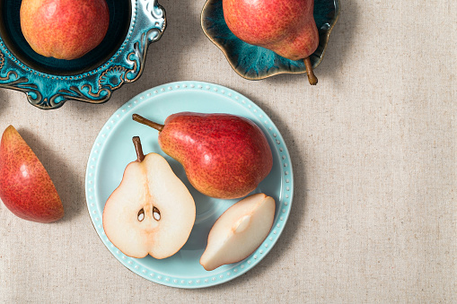 Red pears on blue vintage plates and cotton flowers