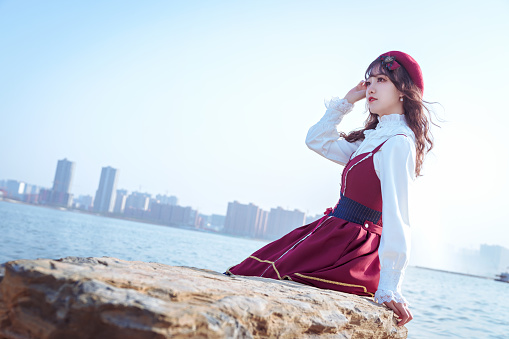 A girl in a red skirt under the blue sky