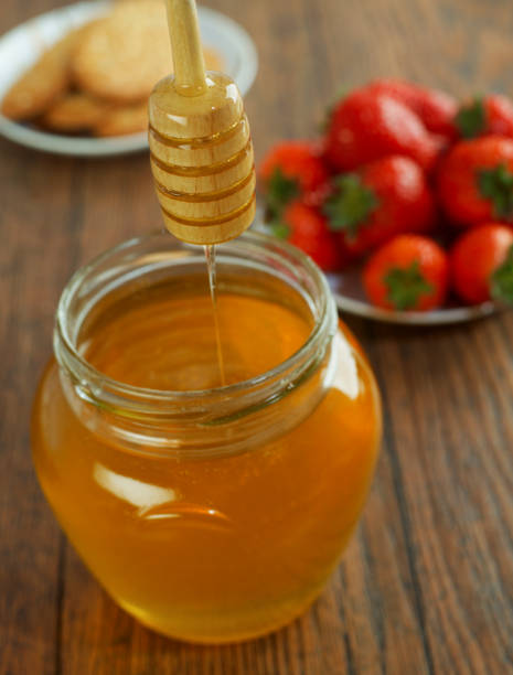istock Honey, cookies and strawberries 1301372480