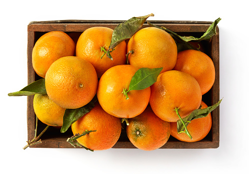 Tangerines in a crate isolated on white