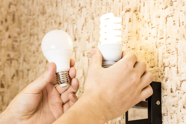 istock handyman changing electricity efficiency light bulb concept. various light bulbs at person hand. replacing lightbulb at wall lamp 1301373745