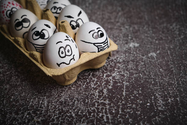 istock white eggs with drawn funny faces wearing medical masks at Easter holiday 1301376275
