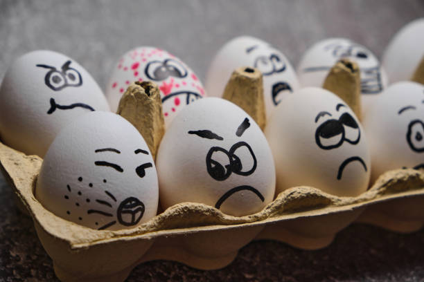 istock white eggs with drawn funny faces wearing medical masks at Easter holiday 1301376310