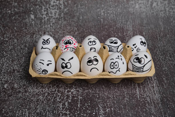 istock white eggs with drawn funny faces wearing medical masks at Easter holiday 1301376458