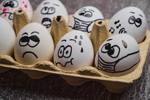 istock white eggs with drawn funny faces wearing medical masks at Easter holiday 1301376988