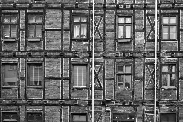 Windows in the frame wall of a historic house in Poznan, monochrome