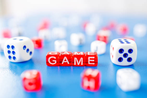 istock the word game is made from red cubes, there are dice next to it 1301379010