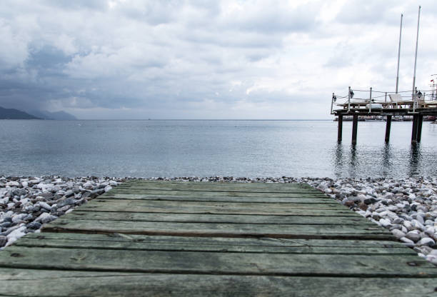 Sea coast and jetty. storm clouds on the sky. Dramatic sky with dark, heavy clouds before storm.
