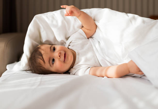 istock Beautiful baby on the bed 1301380877
