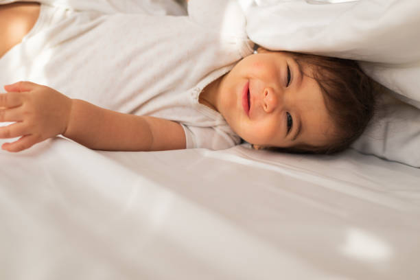 istock Beautiful baby on the bed 1301381343