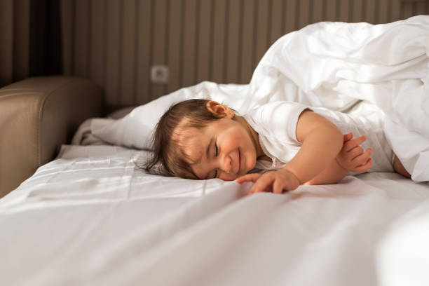 istock Beautiful baby on the bed 1301381489