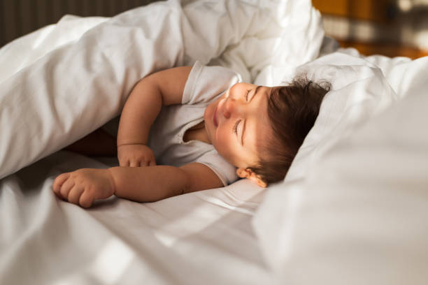 istock Beautiful baby on the bed 1301381875
