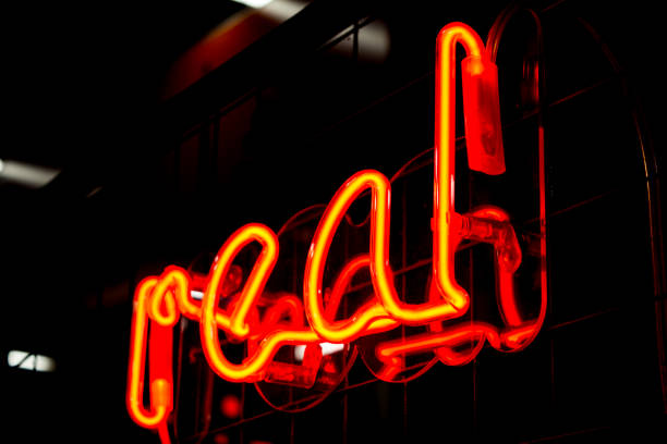 istock Glowing Neon red sign REAL and blurred lights on black background. 1301382981