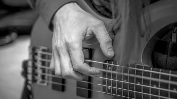 istock musician playing guitar black and white image, close up 1301383025