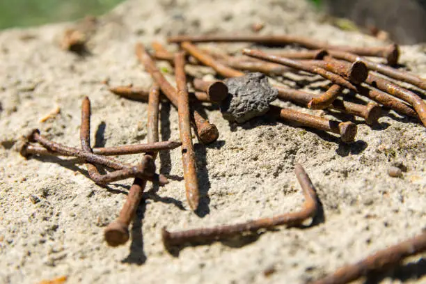 Photo of Old Rusty Nails on concrete.
