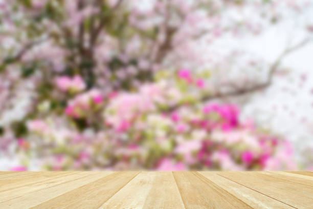 istock Empty top wooden table on blurred sweet flowers in summer for background 1301384069