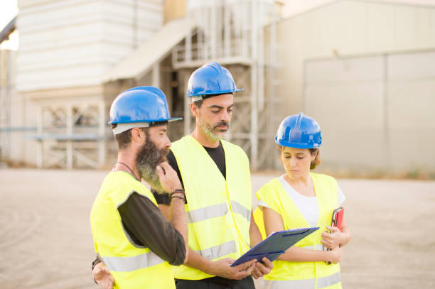 istock workers in a cement factory work outdoors with a tablet planning their work and checking concrete structures.Teamwork 1301385786